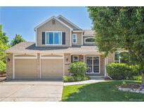 Charming two-story home with a three-car garage and well-maintained front yard at 10096 Hughes Pl, Highlands Ranch, CO 80126