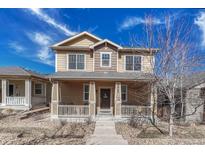 Inviting two-story home with a charming covered front porch and well-maintained landscaping at 3793 Cadence Dr, Castle Rock, CO 80109