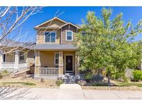 Charming two-story home with a welcoming front porch and well-maintained landscaping and a lovely 'hello' wreath at 3793 Cadence Dr, Castle Rock, CO 80109