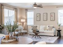 Bright living room with large windows, modern decor, and hardwood floors at 3793 Cadence Dr, Castle Rock, CO 80109