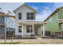 Charming two-story home with a covered front porch, white siding, and modern design at 918 Promenade Dr, Superior, CO 80027