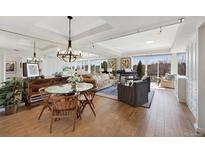 Expansive living room featuring hardwood floors, natural light, stylish furnishings, and a dining area at 1900 E Girard Pl # 500, Englewood, CO 80113