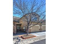 Inviting home exterior with attached garage, stone accents, manicured lawn, and charming curb appeal at 11257 W Radcliffe Dr, Littleton, CO 80127