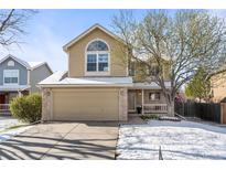 Charming two-story home with a well-manicured lawn and attached two-car garage at 18734 E Linvale Pl, Aurora, CO 80013