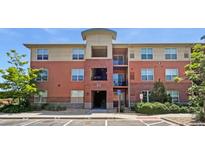 Attractive brick apartment building with mature trees and manicured landscaping at 4100 Albion St # 523, Denver, CO 80216