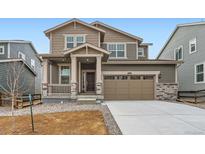 Two-story home featuring a two-car garage, covered porch, and neutral color scheme at 5578 Inland Ave, Firestone, CO 80504