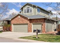 Charming two-story home featuring a brick facade and a spacious two-car garage at 4094 Bimini Ct, Boulder, CO 80301