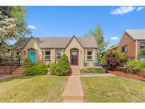 Charming brick home with a well-manicured lawn and inviting front porch seating at 2435 N Irving St, Denver, CO 80211