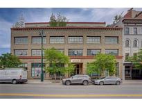 Street view of West End Lofts, a brick building with large windows and trees lining the street at 1435 Wazee St # 408, Denver, CO 80202