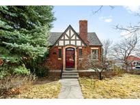 Charming brick home with a red front door and classic Tudor-style detailing at 4938 W Hayward Pl, Denver, CO 80212