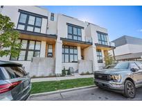 Contemporary home featuring modern design with large windows and an inviting entrance at 4214 E 8Th Pl, Denver, CO 80220