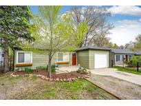 Charming single-story home with a well-maintained front yard and a detached garage, perfect for a cozy Gathering at 1945 Yosemite St, Denver, CO 80220