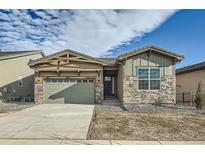 Beautiful single-story home featuring stone accents, a two-car garage, and manicured landscaping at 2978 Newfound Lake Rd, Berthoud, CO 80513