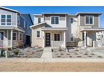 Charming two-story townhome with stone accents and a well-maintained landscaped front yard at 1264 Penner Dr, Erie, CO 80026