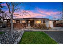 Brick ranch home with landscaped yard and mature trees at 8089 Greenwood Blvd, Denver, CO 80221