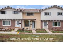 Charming townhome featuring a brick facade and well-maintained front yard at 12661 W Alameda Dr, Lakewood, CO 80228