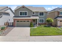 Charming two-story home with a well-manicured lawn, brick accents and an attached two car garage at 42 Blue Sage, Littleton, CO 80127