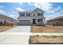 Charming two-story home with a covered porch, two car garage, and neutral color scheme at 1376 Lumber Ridge N Cir, Erie, CO 80516