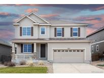 Lovely two-story house featuring a welcoming porch and a spacious two-car garage at 7812 Blue Water Ln, Castle Rock, CO 80108
