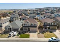 Charming neighborhood street view showcasing the exteriors of well-maintained homes with front lawns at 7812 Blue Water Ln, Castle Rock, CO 80108