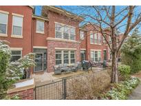 Charming red brick townhome with a cozy outdoor patio and seating area at 8977 E Otero Pl, Centennial, CO 80112