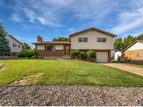 Charming two-story home with brick and siding exterior, well-manicured lawn, and attached one car garage at 10371 Monterey Cir, Northglenn, CO 80260