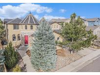 Charming home with a turret entrance, red door and mature landscaping creating great curb appeal at 2823 Danbury Ave, Highlands Ranch, CO 80126