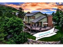 Inviting home featuring a large outdoor deck, lush landscaping, and a scenic view perfect for entertaining at 3254 Red Tree Pl, Castle Rock, CO 80104