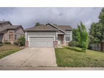 Charming single-Gathering home featuring a two-car garage and well-maintained front yard with mature trees at 19688 E Lasalle Dr, Aurora, CO 80013