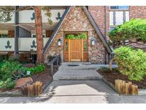 Charming entryway with stone facade and wooden door framed by decorative glass sidelights at 1260 York St # 204, Denver, CO 80206