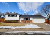 Charming two-story home featuring a well-maintained lawn, brick accents, and an attached two-car garage at 315 E 112Th Dr, Northglenn, CO 80233