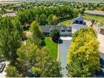 Spacious home with detached garage and expansive yard, offering ample space and privacy at 6460 E 165Th Ct, Brighton, CO 80602