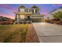 Charming two-story home with a welcoming porch and manicured front yard at 24394 E Dorado Pl, Aurora, CO 80016