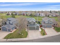 Beautiful home with golf course views, green lawn, and a long driveway with basketball hoop at 13420 Lafayette St, Thornton, CO 80241