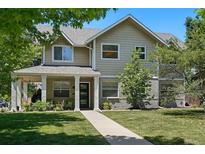 Charming two-story home featuring a welcoming front porch and well-maintained lawn at 751 Poplar St, Denver, CO 80220
