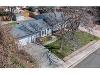 Charming single-story home featuring a landscaped front yard and long driveway at 11125 W Alamo Pl, Littleton, CO 80127