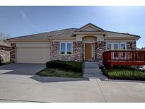 Charming single-story home featuring a stone facade, covered entry, and a two car garage at 13941 E Whitaker Dr, Aurora, CO 80015