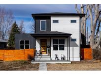Charming two-story home with black and white siding, front porch, and modern design at 2111 S Franklin St, Denver, CO 80210