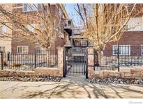 Charming brick condo building with secure gated entry and mature trees at 2345 N Clay St # 6, Denver, CO 80211