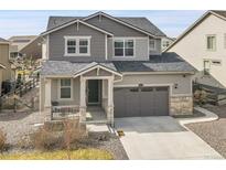 Charming two-story home with a covered front porch, two-car garage, and low maintenance front yard at 4884 St Vrain Rd, Firestone, CO 80504