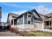 Charming home with two-car garage, blue and beige siding, and well-kept landscaping at 6311 Stable View St, Castle Pines, CO 80108