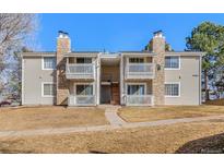 Inviting condo exterior featuring stone accents, balconies and well-maintained landscaping at 14182 E Colorado Dr # 204, Aurora, CO 80012