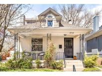 Charming front exterior with white brick, decorative ironwork, and inviting porch seating at 3719 W 30Th Ave, Denver, CO 80211