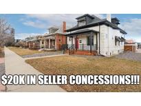 Charming two-story home with a welcoming front porch and manicured lawn at 3800 Umatilla St, Denver, CO 80211