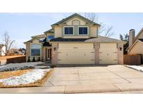 Charming two-story home featuring a spacious three-car garage and a well-maintained front yard at 9632 Dolton Ct, Highlands Ranch, CO 80126