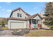 Charming two-story home with attached garage and covered front porch at 57 Audrey Cir, Breckenridge, CO 80424