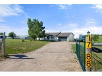 Charming single-story home with a long driveway, well-maintained lawn, and inviting curb appeal at 1788 Shoshone Trl, Elizabeth, CO 80107
