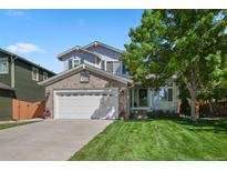 Charming two-story home featuring a well-maintained lawn, brick accents, and a spacious two-car garage at 19118 E Grand Cir, Aurora, CO 80015