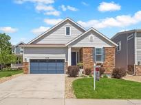 Charming single-Gathering home with a two-car garage, stone accents, and a well-manicured lawn at 6174 Flattop St, Golden, CO 80403
