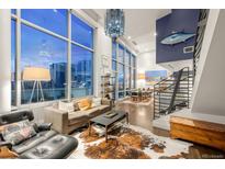 Bright living room with floor-to-ceiling windows, hardwood floors, comfortable seating, and modern decor, offering great city views at 55 W 12Th Ave # 608, Denver, CO 80204